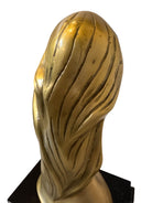 Cast bronze bust of a woman, mid-century Korean design, on a dark wood base. The figure has stylized flowing hair and no mouth.
