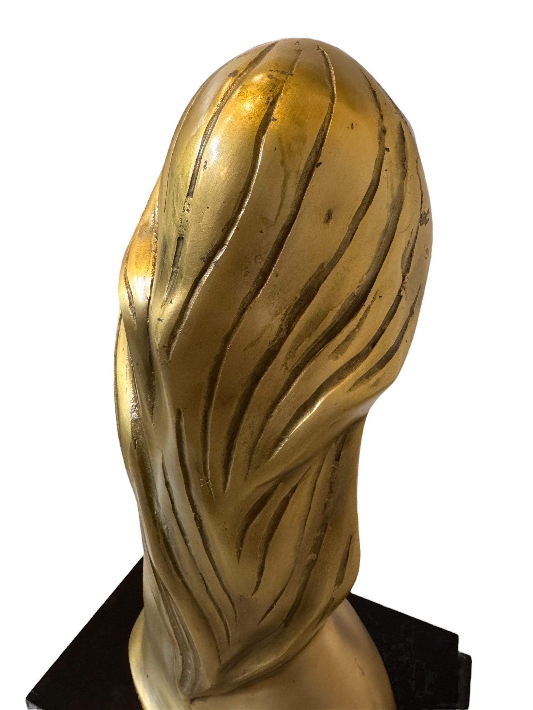 Cast bronze bust of a woman, mid-century Korean design, on a dark wood base. The figure has stylized flowing hair and no mouth.