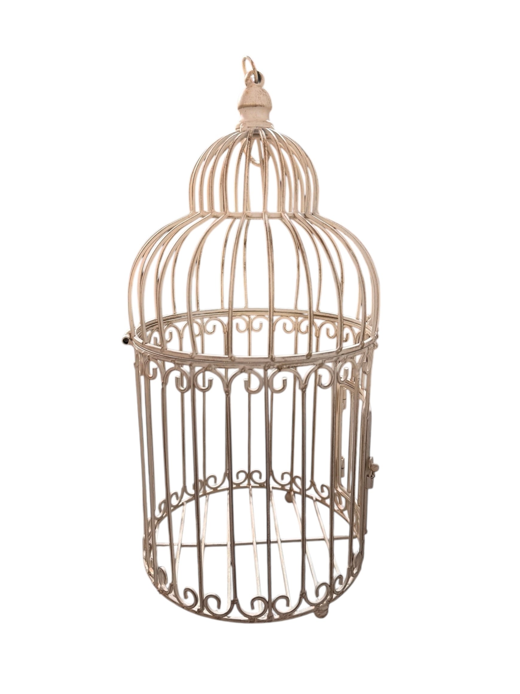 A single, white or cream-colored, decorative wrought iron bird cage with a hinged door and a hanging loop at the top. The cage has a vintage or antique style 