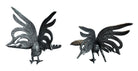 A pair of vintage, silver-plated brass fighting rooster figurines positioned in a confrontational stance against a white background. The rooster on the left is crouched low with its head down and tail feathers fanned high, while the rooster on the right stands more upright with its wings slightly flared. Both feature intricate feather detailing, a metallic patina showing hints of brass through the silver, and small, bright red glass eyes.