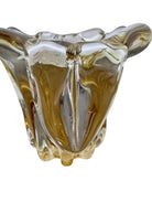 A hand-blown art glass vase with a scalloped, tulip-shaped rim, featuring an amber-to-clear color gradient and a ribbed base