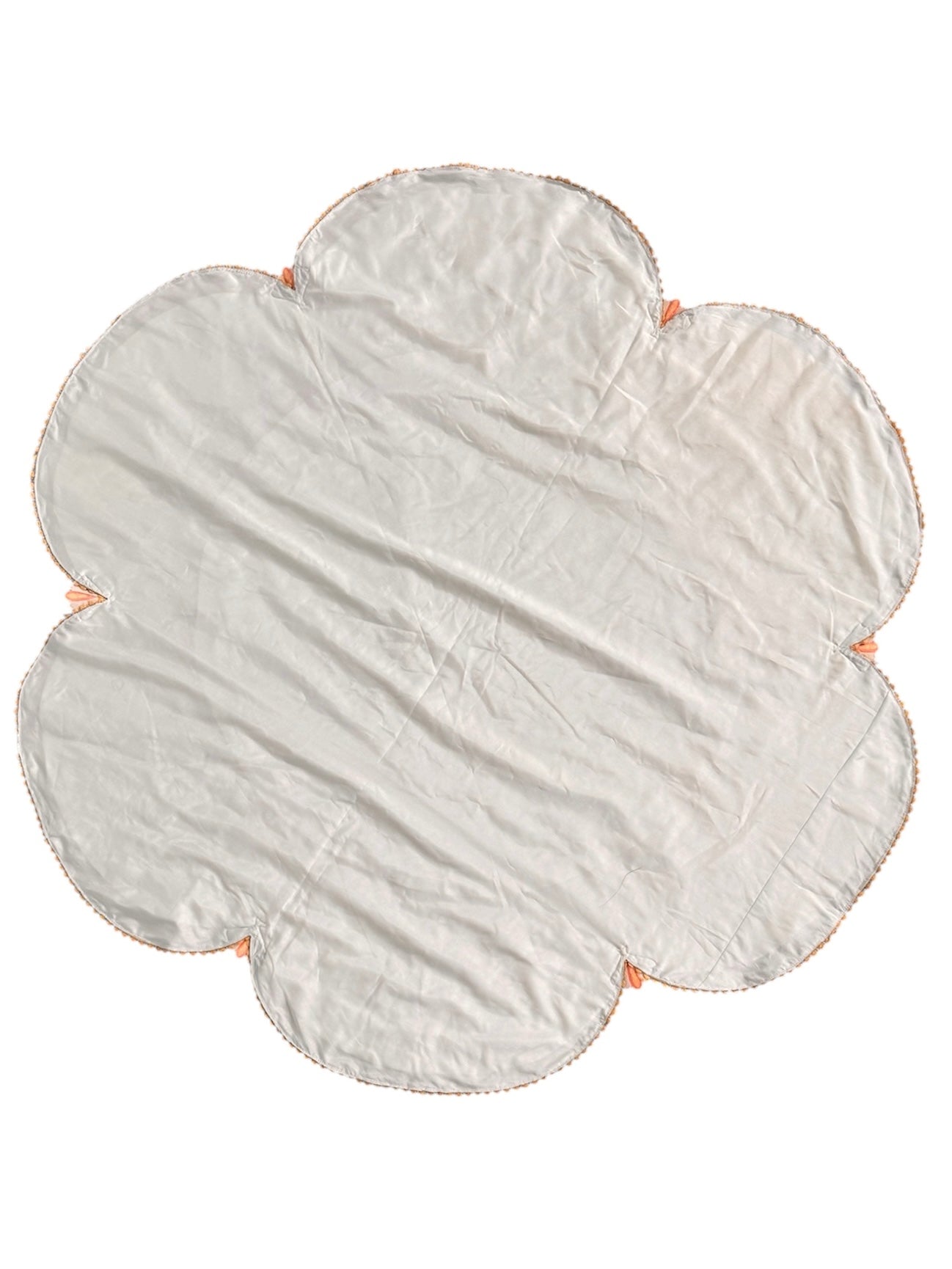 A round, cream-colored tablecloth featuring a dramatic, scalloped border shaped like six large flower petals. The border is intricately embroidered with a coastal motif including pink starfish, seashells, and teal-blue swirling waves. Gold beaded accents line the inner circular seam and the outer edges.
A long, narrow cream runner with matching scalloped, wavy edges. It is adorned with the same nautical embroidery of pink starfish and seashells scattered across the center and concentrated along the edge.