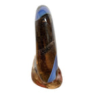 An asymmetrical Murano art glass sculpture with a heavy, biomorphic form. The piece is composed of thick, translucent smoky-amber glass with abstract, fluid bands of deep blue and dark brown swirling throughout the upper rim and sides. A dense pattern of tiny, controlled air bubbles is suspended inside the glass, concentrating heavily near the thick, solid amber base.