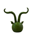 Glossy green ceramic pig sculpture with exaggerated, upward-curving horns and a snout.
