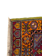 Anatolian Yastik rug with red, gold, green and gray geometric patterns and fringe.
