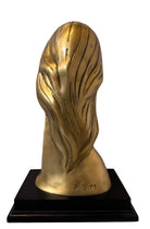 Cast bronze bust of a woman, mid-century Korean design, on a dark wood base. The figure has stylized flowing hair and no mouth.