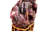 An antique Chinese table lamp featuring a base hand-carved from deep purple amethyst stone, topped with a clear quartz crystal neck. The lamp sits on an ornate, custom gilt-bronze Chinoiserie base and features a flared, cream-colored silk lampshade still enclosed in protective plastic. A rectangular brass finial sits at the very top.