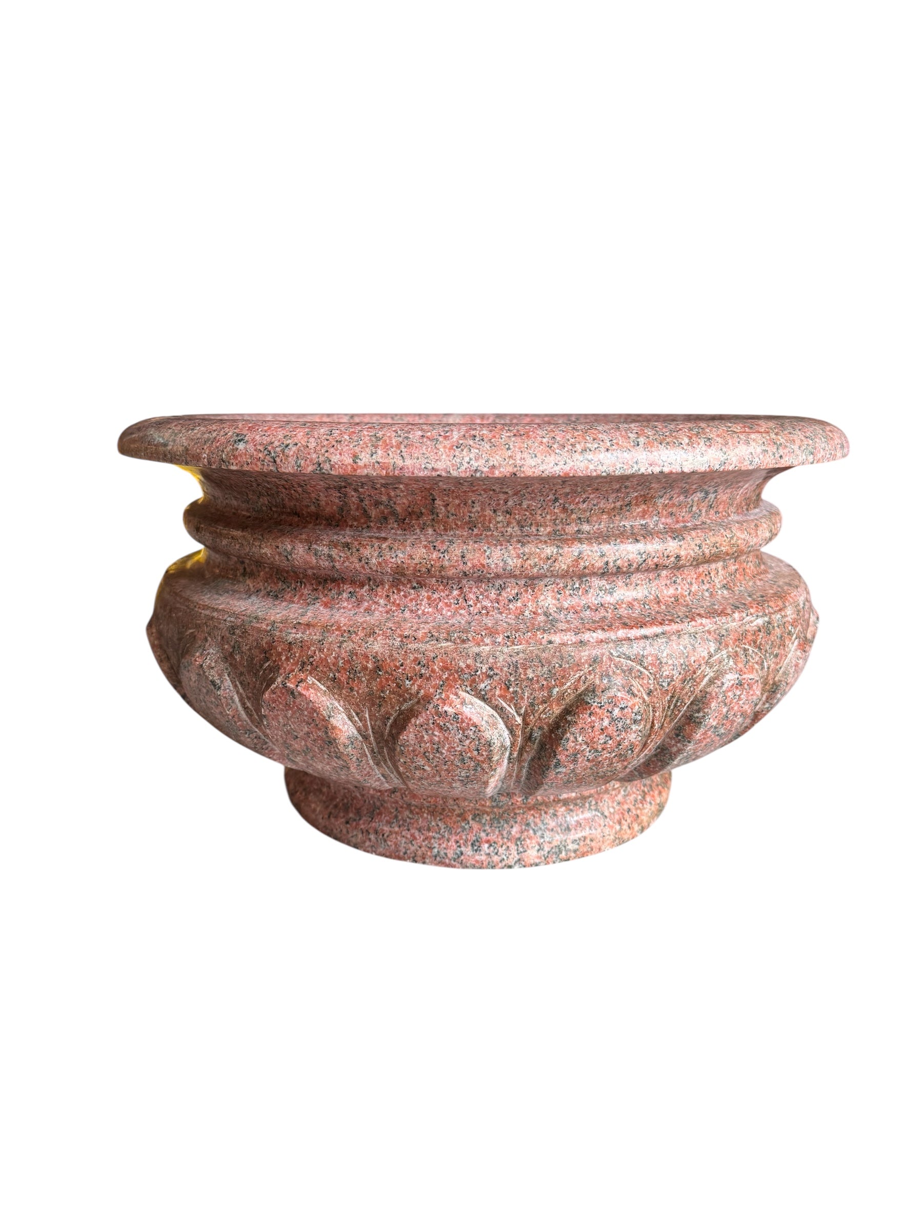A carved pink granite planter with a leaf pattern, designed for indoor use without drainage.