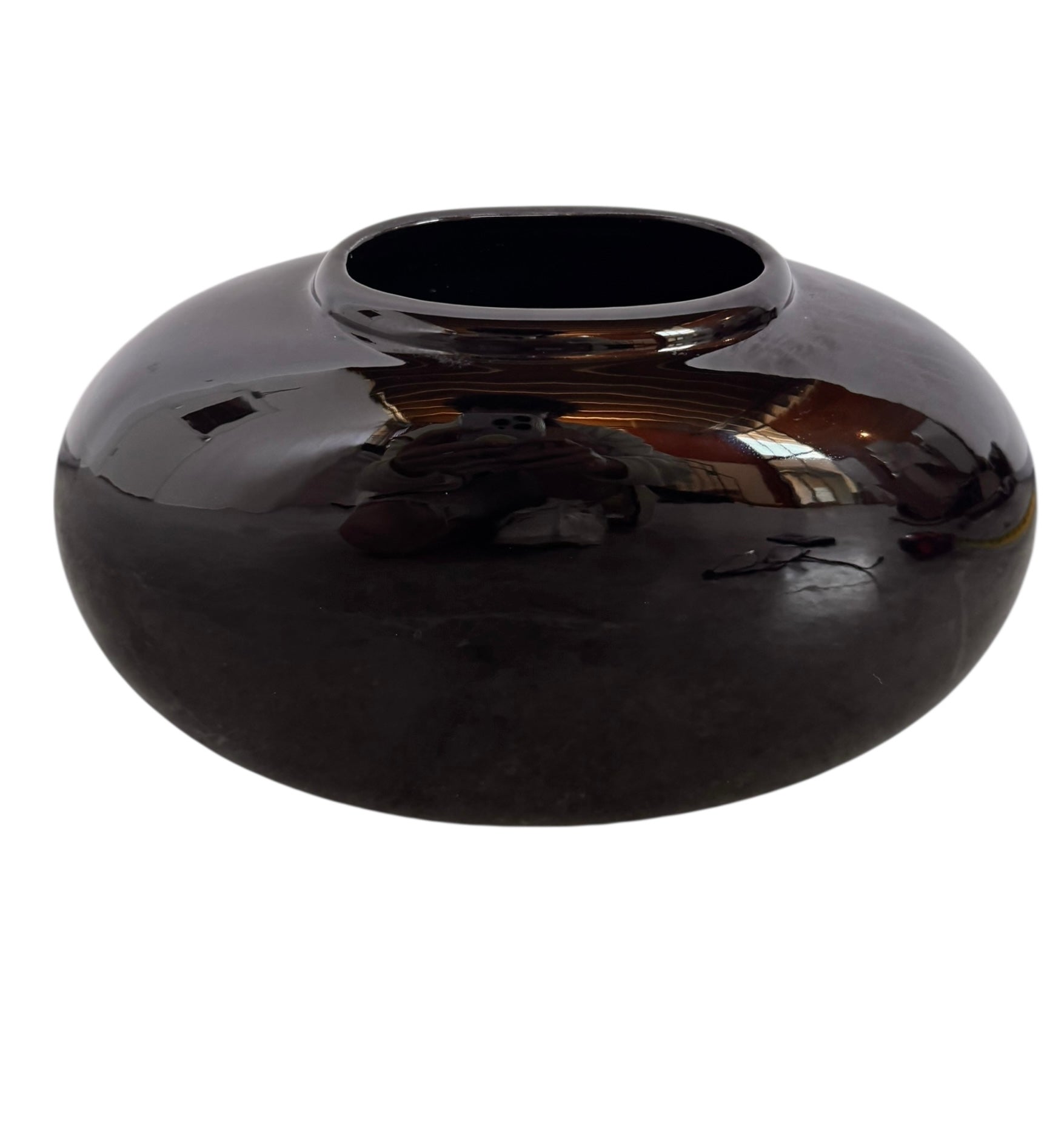 A round, glossy black vase with a small opening.
The vase has a spherical or gourd-like shape and a highly reflective, black glazed finish.
