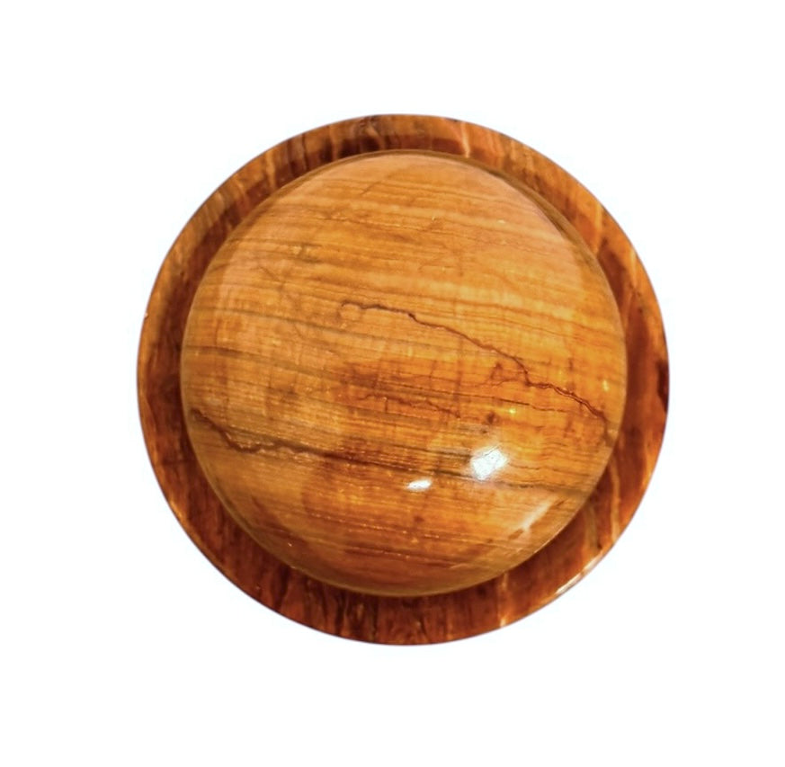 An elegant, hand-carved decorative vase made of polished Pakistani brown onyx. The vase features a classic, rounded urn shape with a tiered, flared neck and a solid matching spherical stone stopper resting on top. The stone displays rich, natural horizontal banding and swirling patterns in shades of honey, deep amber, rust-red, and cream. It stands on a small, integrated pedestal base against a clean white background, reflecting a high-gloss, mirror-like finish.