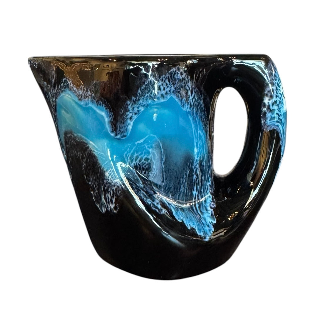 Complete mid-century ceramic tea set with teapot, sugar bowl, cups, and saucers, featuring a bold blue and black "lava drip" glaze reminiscent of Vallauris pottery.