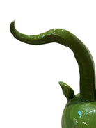 Glossy green ceramic pig sculpture with exaggerated, upward-curving horns and a snout.