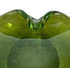 A vintage, Mid-Century Modern, peridot green art glass ashtray or catchall bowl with a curved, free-form design.