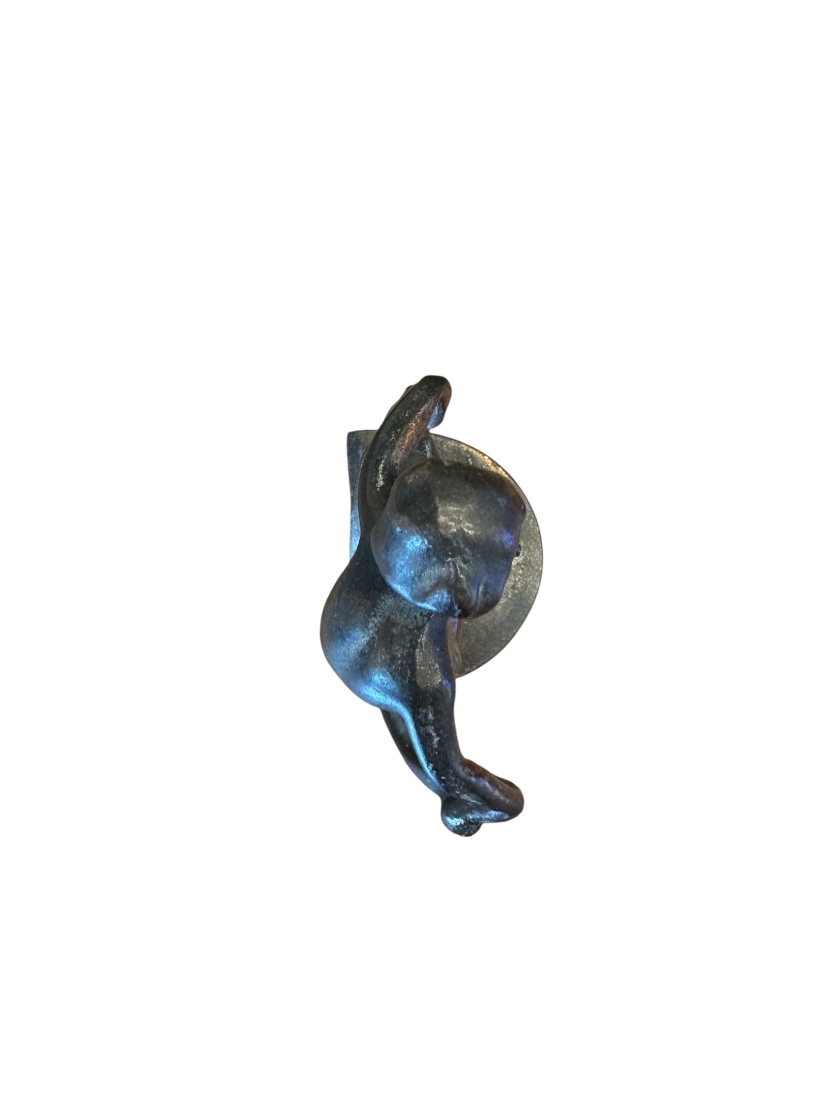 Two cast iron bookends in the Art Deco style. Each features a nude female figure leaning gracefully with one leg extended, posed atop a stylized wave or drape. The bookends have a bronze-colored finish and a vintage appearance.