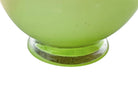 A mid-century modern, lime green cased-glass vase with a wide, flared rim and a thick, clear glass base. The exterior is a glossy chartreuse green, while the interior is lined with solid milk-white glass. The defining feature is a large, vertical oval cutout window that pierces directly through the center of the vase's body, creating an open-air negative space.