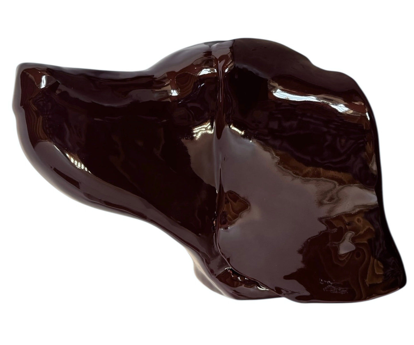 A glossy, dark chocolate brown ceramic bust of a Labrador dog. Created by Enza Fasano, the sculpture features a minimalist, stylized design with smooth, flowing lines and a high-shine glaze that reflects light. The dog’s long ears drape down the sides, and its snout is rounded, capturing the gentle essence of the breed in a contemporary Italian pottery style.