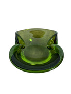 A vintage, Mid-Century Modern, peridot green art glass ashtray or catchall bowl with a curved, free-form design.