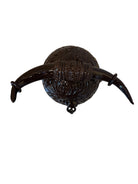 Glossy dark brown ceramic bull sculpture with intricate, hand-incised swirling patterns and a nose ring.