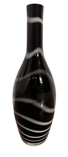 A sleek, hand-blown Polish art glass vase featuring a tall, slender neck that flares into a rounded, bulbous body. The vase is made of opaque black glass decorated with a continuous white spiral ribbon that winds around the entire piece from base to rim. The high-gloss, reflective surface creates sharp highlights, emphasizing its smooth, sculptural silhouette against a plain white background.
