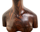 An elegant hand-carved bust of a woman made from rich, polished dark ebony wood with striking reddish-brown grain patterns running vertically through her face and chest. The sculpture features a serene expression with closed eyes, a slender nose, and relaxed lips. Her voluminous, textured hair rises upward in a Fan-like shape, intricately carved with fine lines and adorned with small, delicate flower details. The bust includes her bare shoulders and upper chest, resting on a flat base.
