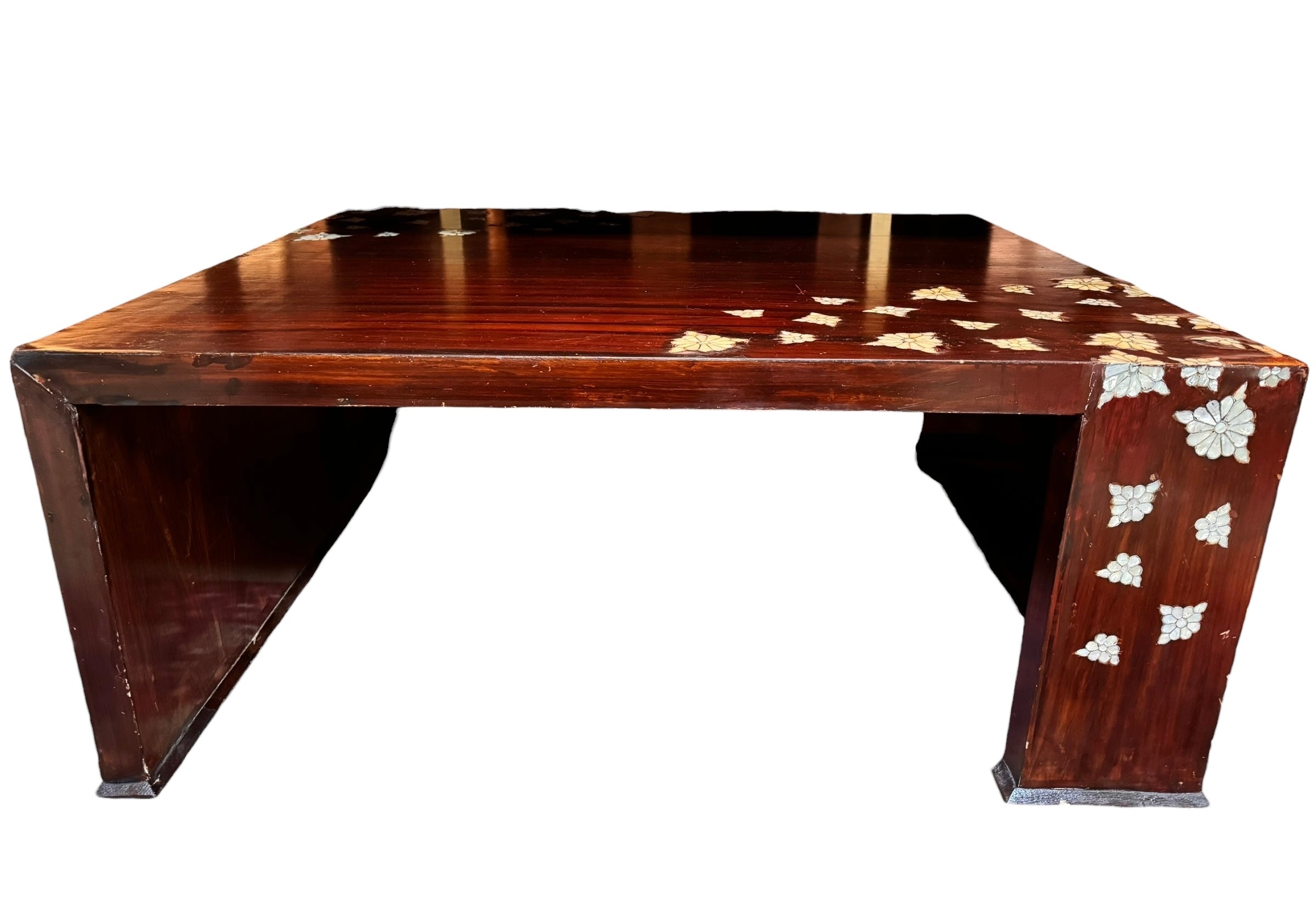 A rectangular, dark wood coffee table featuring scattered floral mother-of-pearl or shell inlays on its top surface and one side. The table has a modern, minimalist U-shaped design