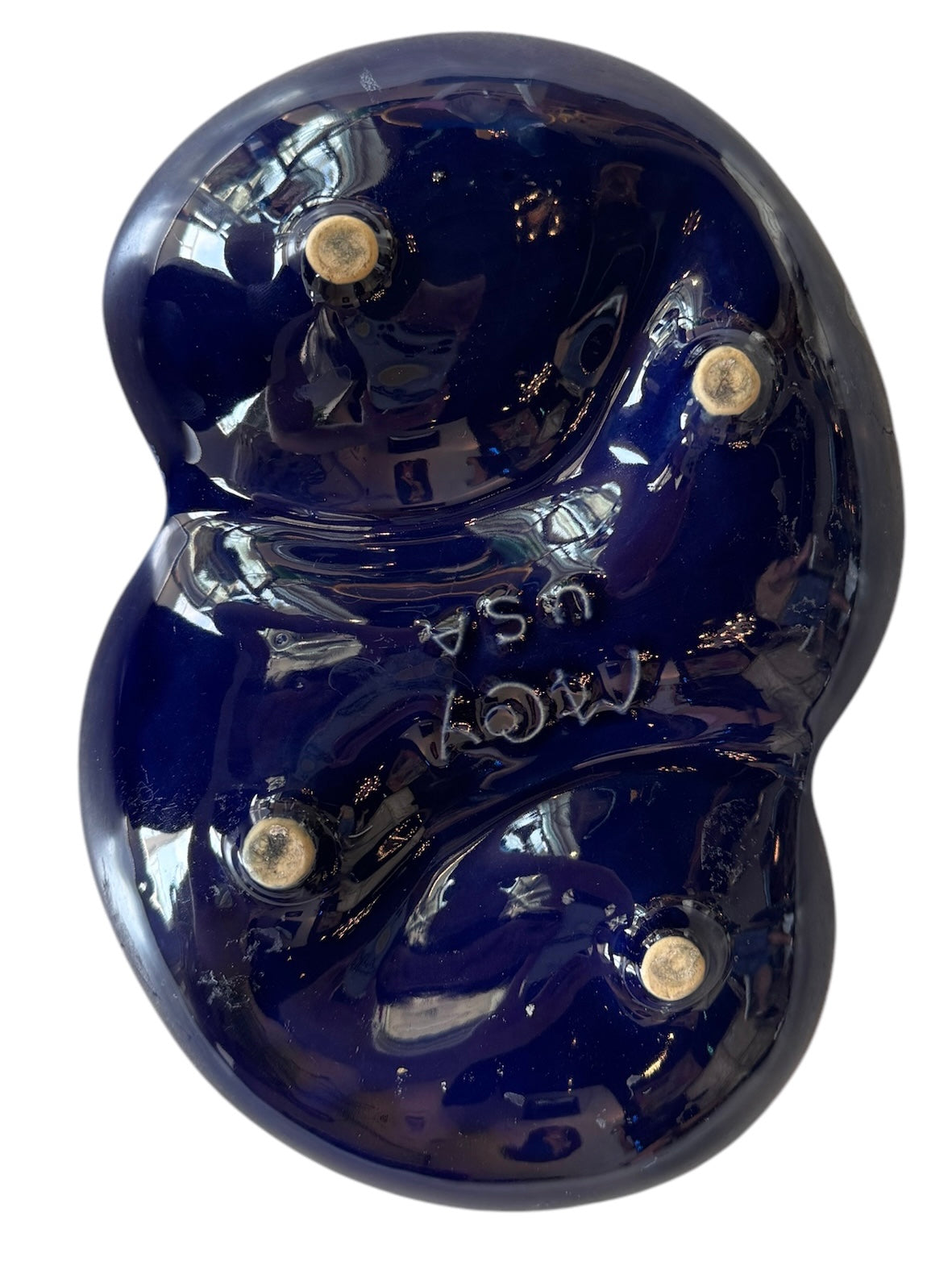 Vintage McCoy ashtray. Glazed in dark blue and marbled with lighter blues. The bottom is stamped 'McCoy USA.'"