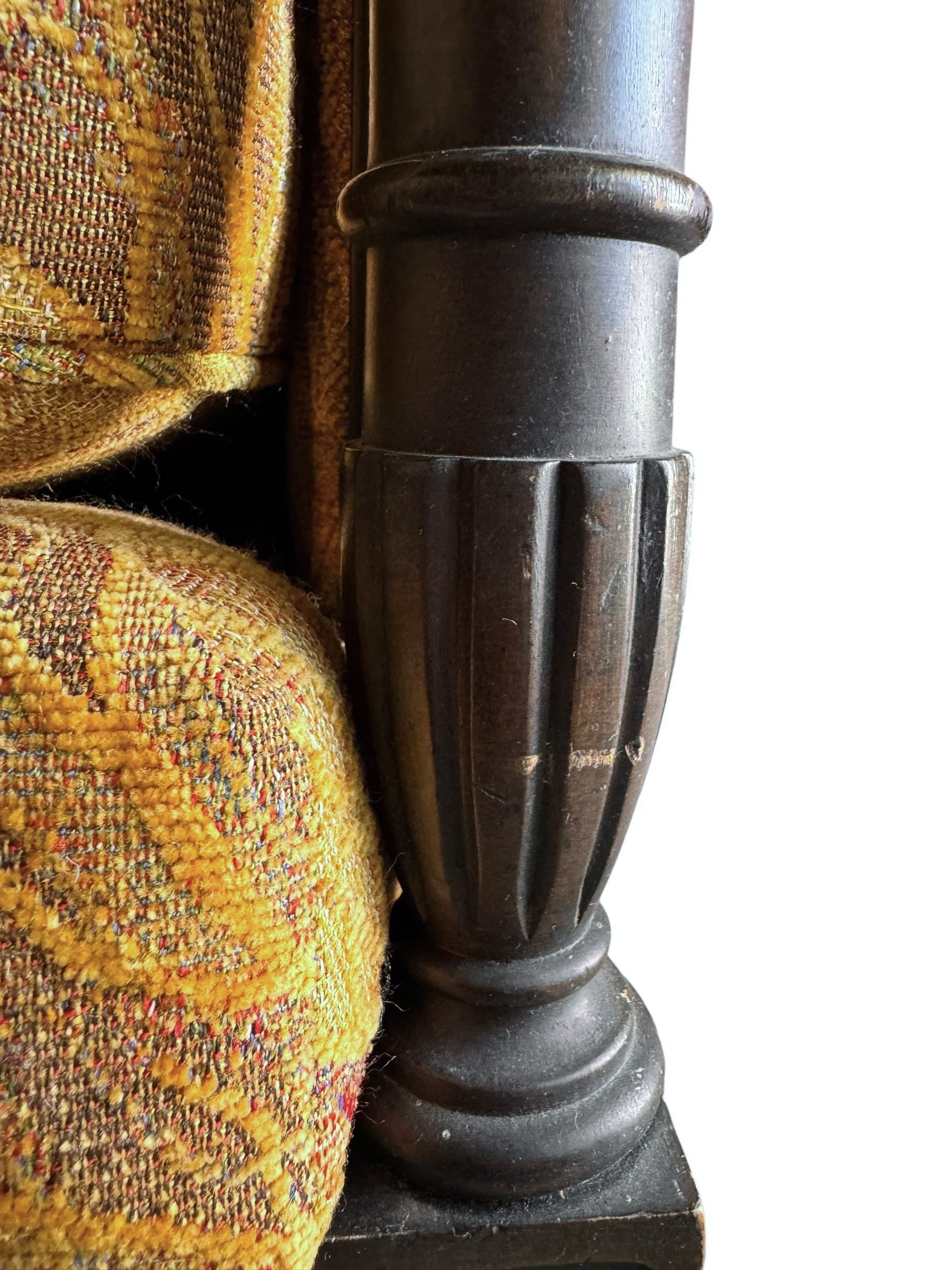 A Neoclassical-style wooden loveseat with a dark mahogany frame featuring scrolled arms and tapered legs. The upholstery consists of plush cushions and two matching cylindrical bolster pillows, all covered in a golden-yellow jacquard fabric with a large-scale, repeating autumnal leaf pattern in shades of muted orange and brown.