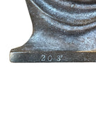 Two cast iron bookends in the Art Deco style. Each features a nude female figure leaning gracefully with one leg extended, posed atop a stylized wave or drape. The bookends have a bronze-colored finish and a vintage appearance.