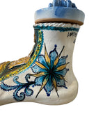 Close-up of Domenico Pinto's 'Mare Dentro' ceramic sculpture: foot, ship with gold sail, Apulian style