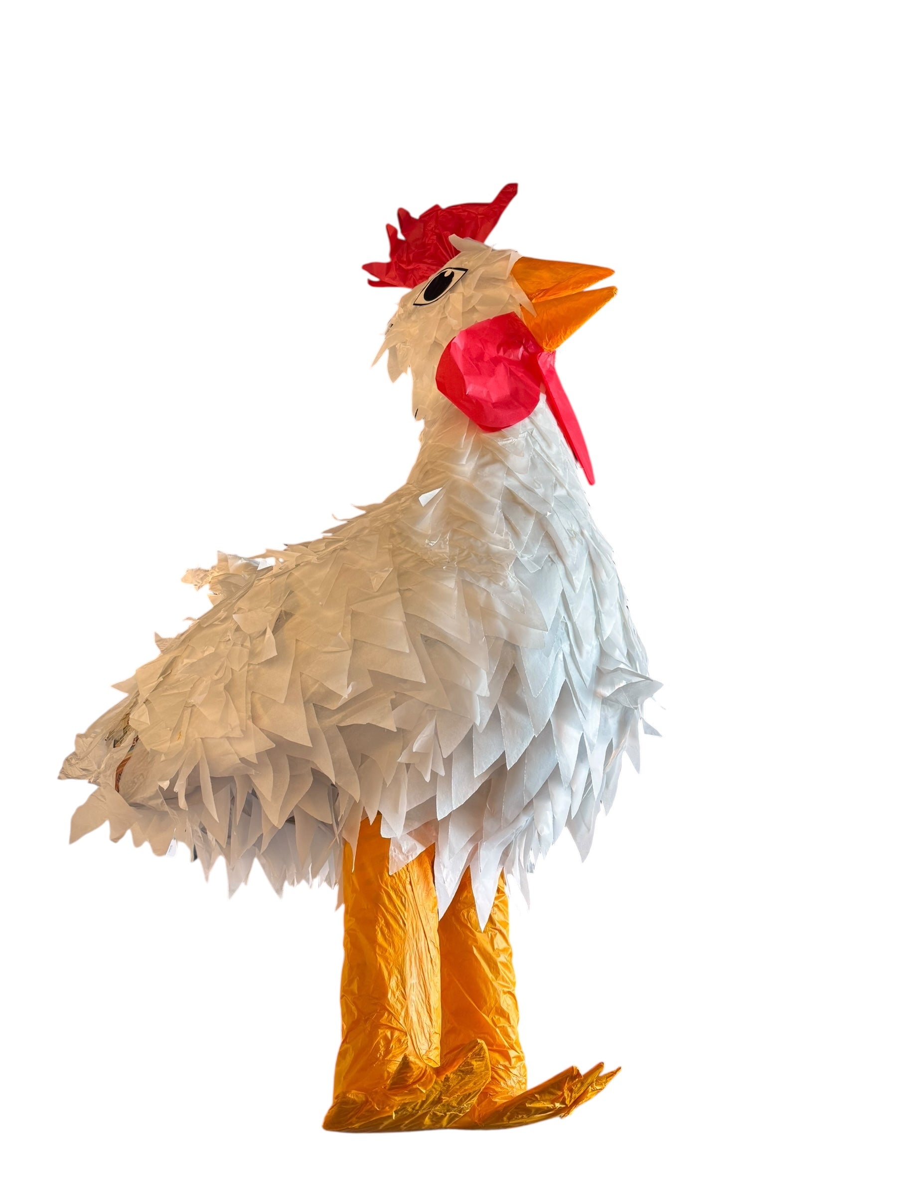 A white chicken pinata with red comb and wattles, and orange beak and legs, standing upright.