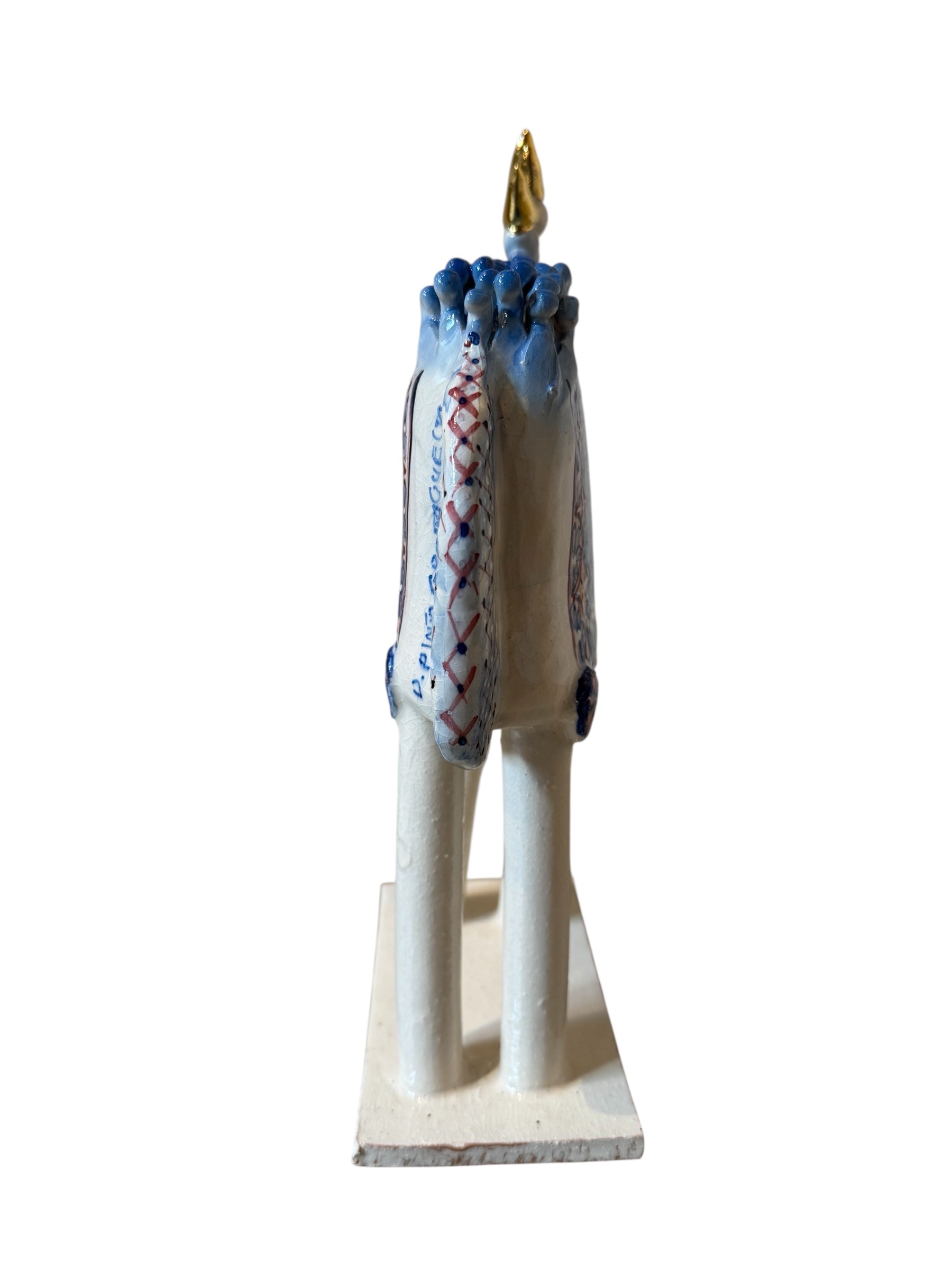 Ceramic horse by Domenico Pinto, featuring a white glazed body, geometric quilting on the saddle, a decorative crown with white and gold accents, and 24Kt gold detailing. The horse stands on four legs and is placed on a white base.