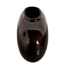 A round, glossy black vase with a small opening.
The vase has a spherical or gourd-like shape and a highly reflective, black glazed finish.
