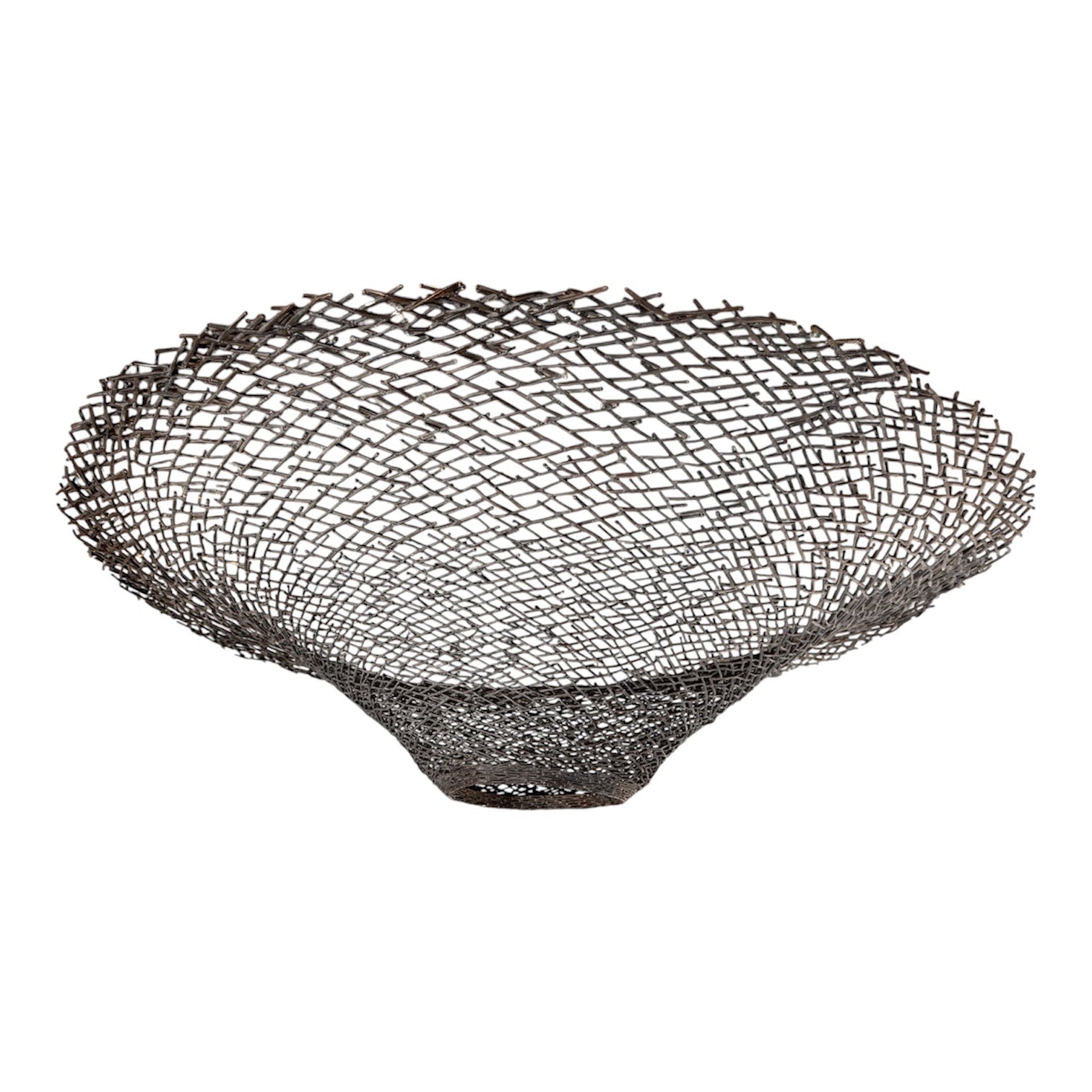 A round metal wall sculpture by Michael Aram, viewed from the front against a stark white background. The piece is composed of a dense, intricate lattice of fine, dark metal wire or twigs woven together to create a textured, web-like pattern. The structure curves inward like a funnel or a vortex, sloping down toward a clean, circular opening in the exact center, creating a strong sense of depth and dimensionality.