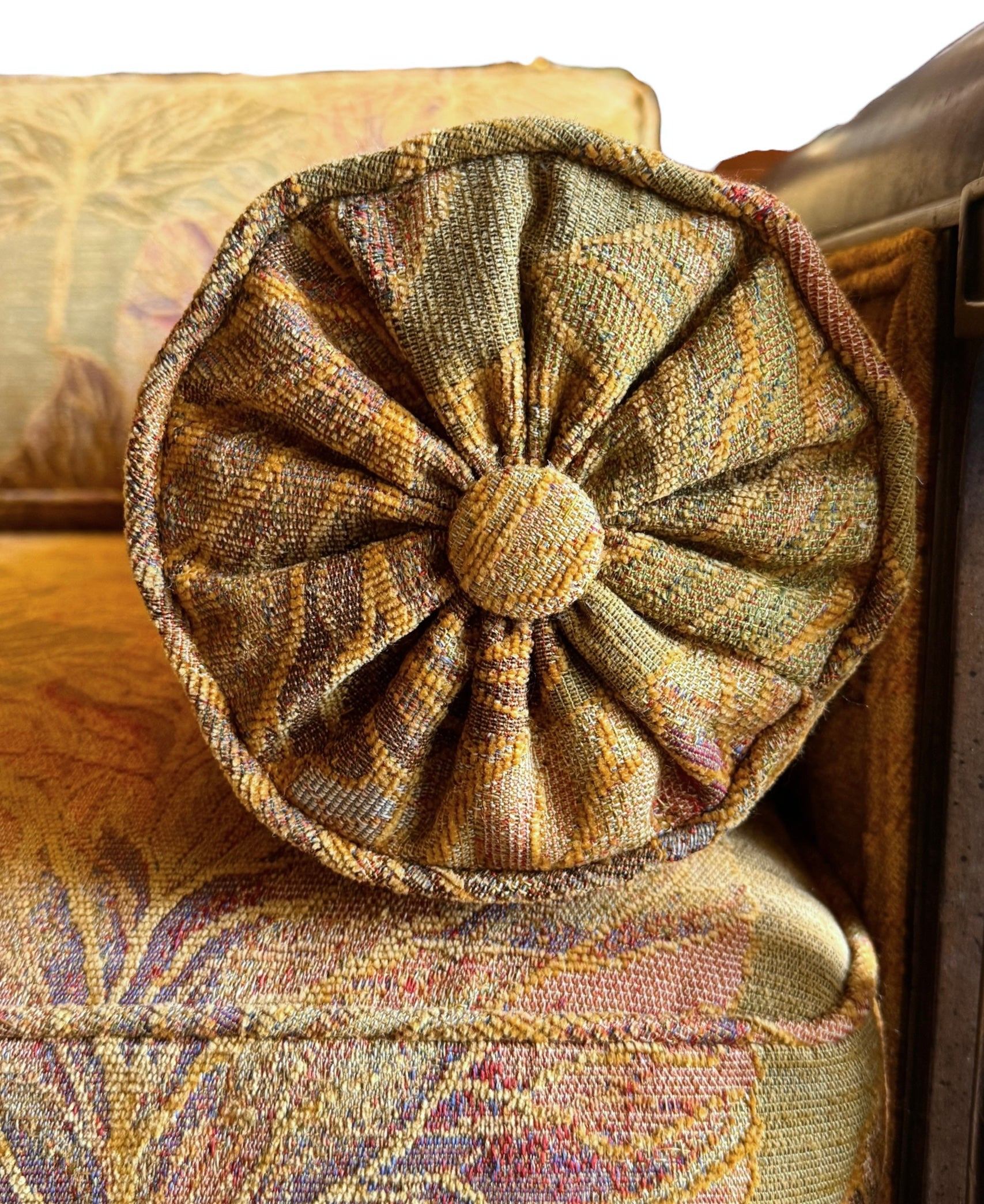 A Neoclassical-style wooden loveseat with a dark mahogany frame featuring scrolled arms and tapered legs. The upholstery consists of plush cushions and two matching cylindrical bolster pillows, all covered in a golden-yellow jacquard fabric with a large-scale, repeating autumnal leaf pattern in shades of muted orange and brown.