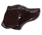 A glossy, dark chocolate brown ceramic bust of a Labrador dog. Created by Enza Fasano, the sculpture features a minimalist, stylized design with smooth, flowing lines and a high-shine glaze that reflects light. The dog’s long ears drape down the sides, and its snout is rounded, capturing the gentle essence of the breed in a contemporary Italian pottery style.