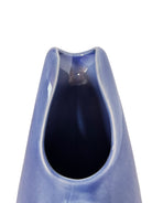 A Russel Wright American Modern stoneware water pitcher in a glossy Manitoga blue glaze is centered against a white background. The pitcher has a teardrop shape, a large handle, and a wide spout