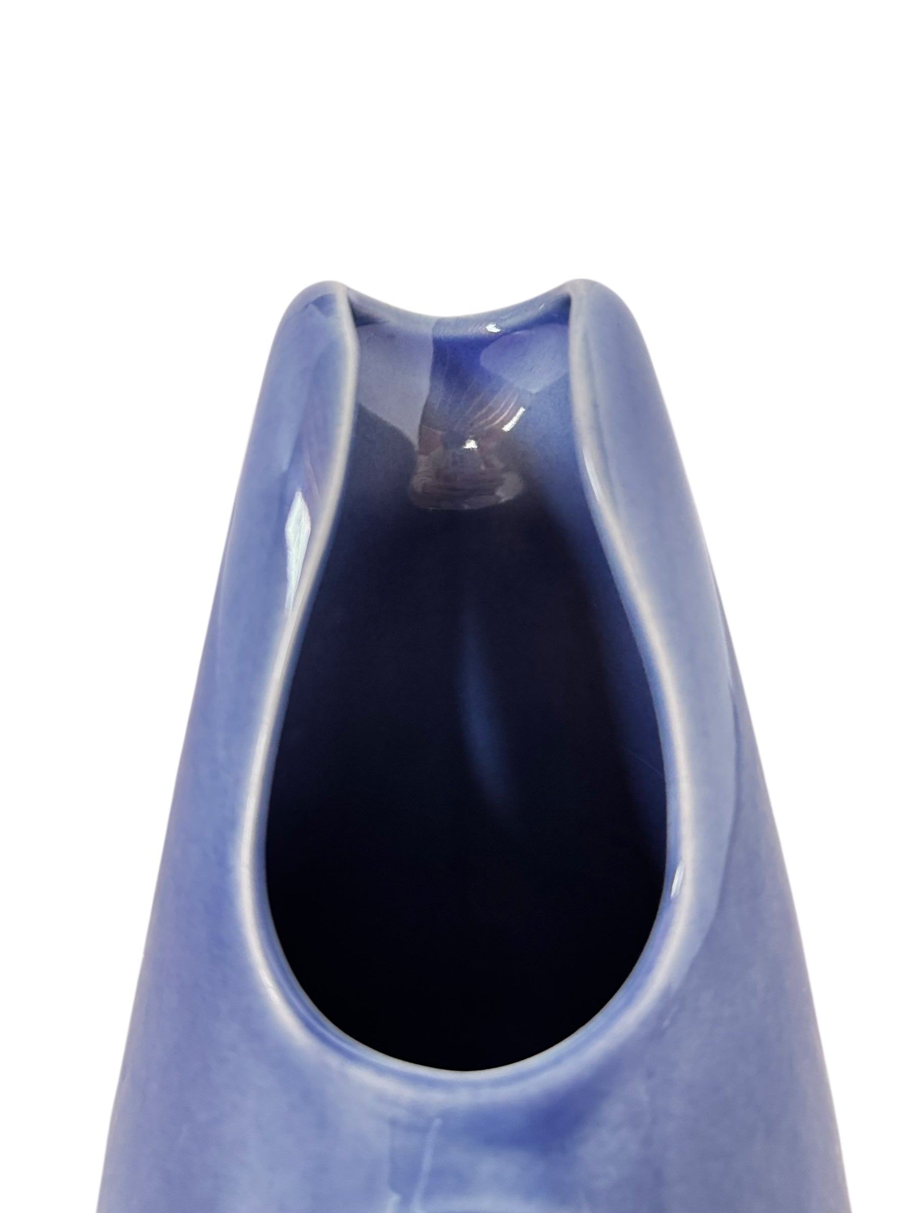 A Russel Wright American Modern stoneware water pitcher in a glossy Manitoga blue glaze is centered against a white background. The pitcher has a teardrop shape, a large handle, and a wide spout