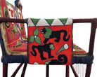 Close-up of a Yoruba beaded armchair, featuring vibrant red, blue, and green beads in a pattern of stylized masks and animals such as lions and zebras