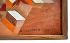 Wooden surface with geometric patterns and a signature 'R Wymer 2025' in the corner.