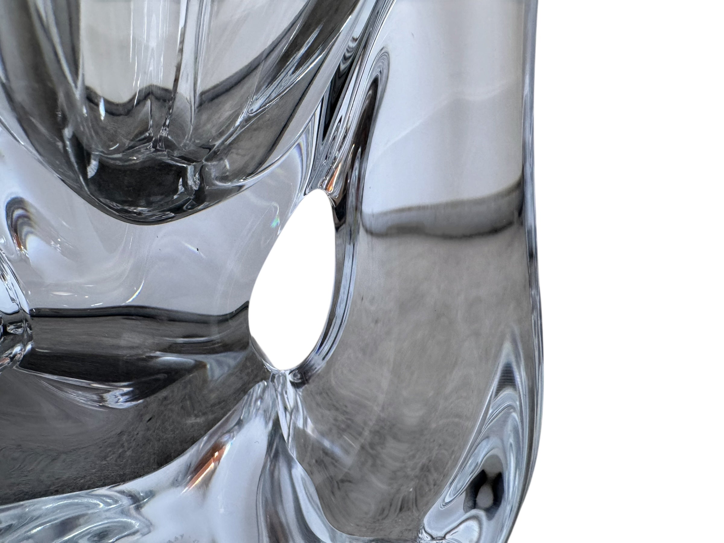 A clear crystal vase with a flared opening and a twisted, sculptural base.
The provided image is of a vintage Vannes Le Châtel crystal vase, which is a piece of French art glass
