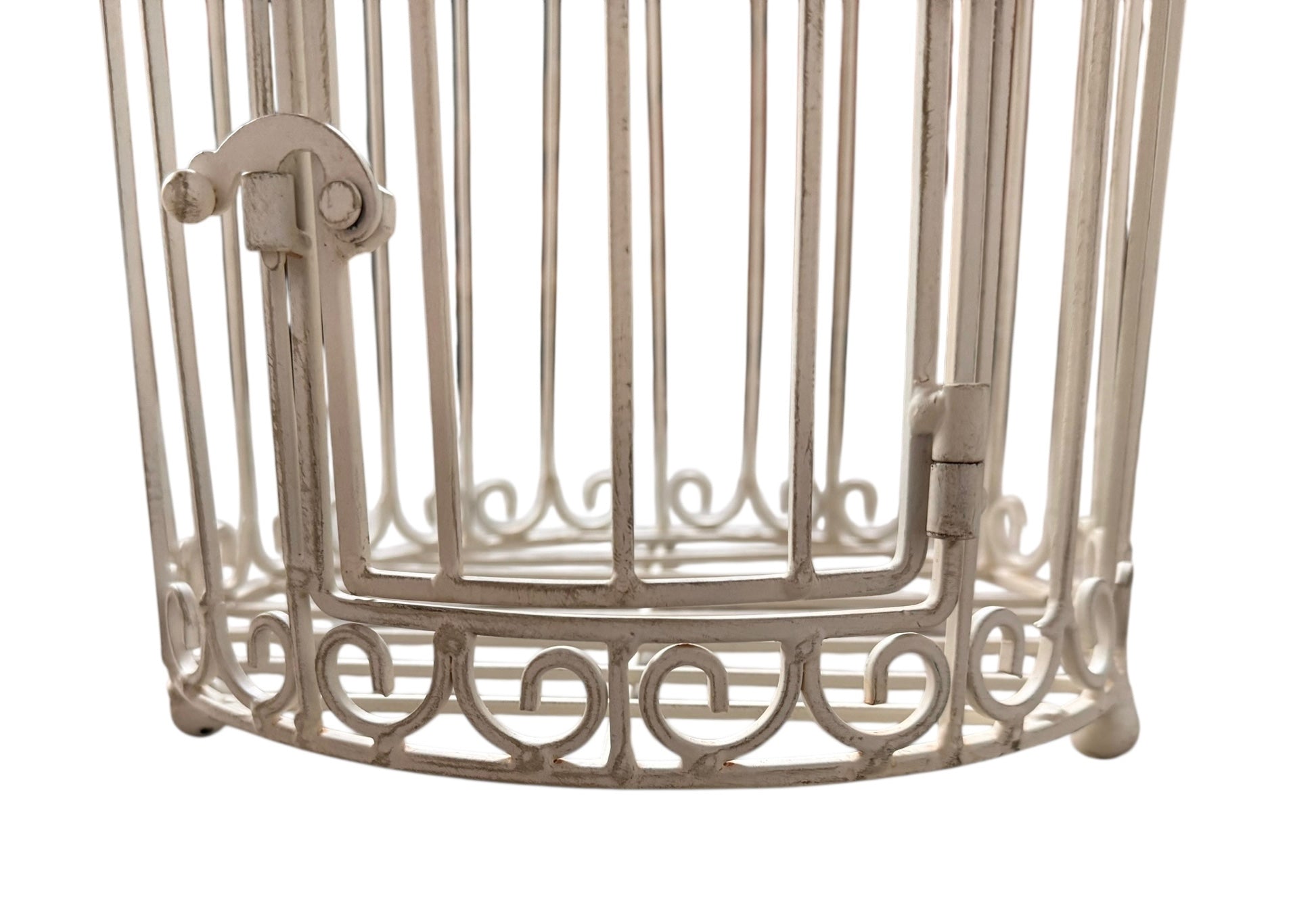 A single, white or cream-colored, decorative wrought iron bird cage with a hinged door and a hanging loop at the top. The cage has a vintage or antique style 