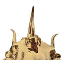 A handcrafted ceramic sculpture of a rhinoceros beetle by Enza Fasano, featuring a brilliant, high-gloss gold metallic finish. The beetle is captured in a dynamic, slightly upturned pose with detailed textures on its ribbed shell and prominent, curved horns. The piece reflects light across its polished surface, showcasing the artist’s signature fusion of traditional Pugliese pottery and contemporary luxury.