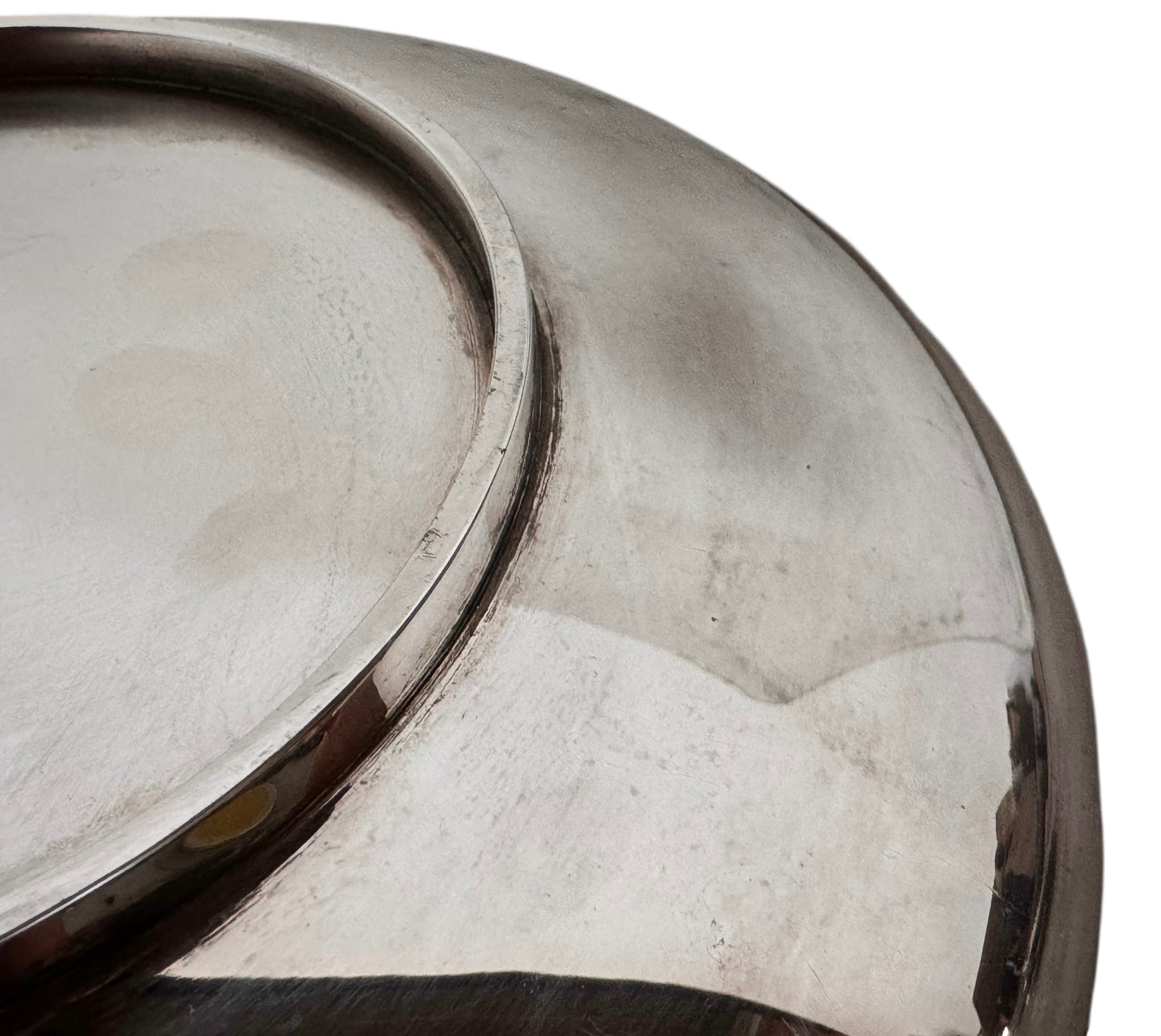 Round St. James silver-plated lidded serving dish from the 1980s, featuring a minimalist modernist design with geometric side handles and a sculptural, biomorphic finial, showing visible vintage wear and pitting on the metallic surface.