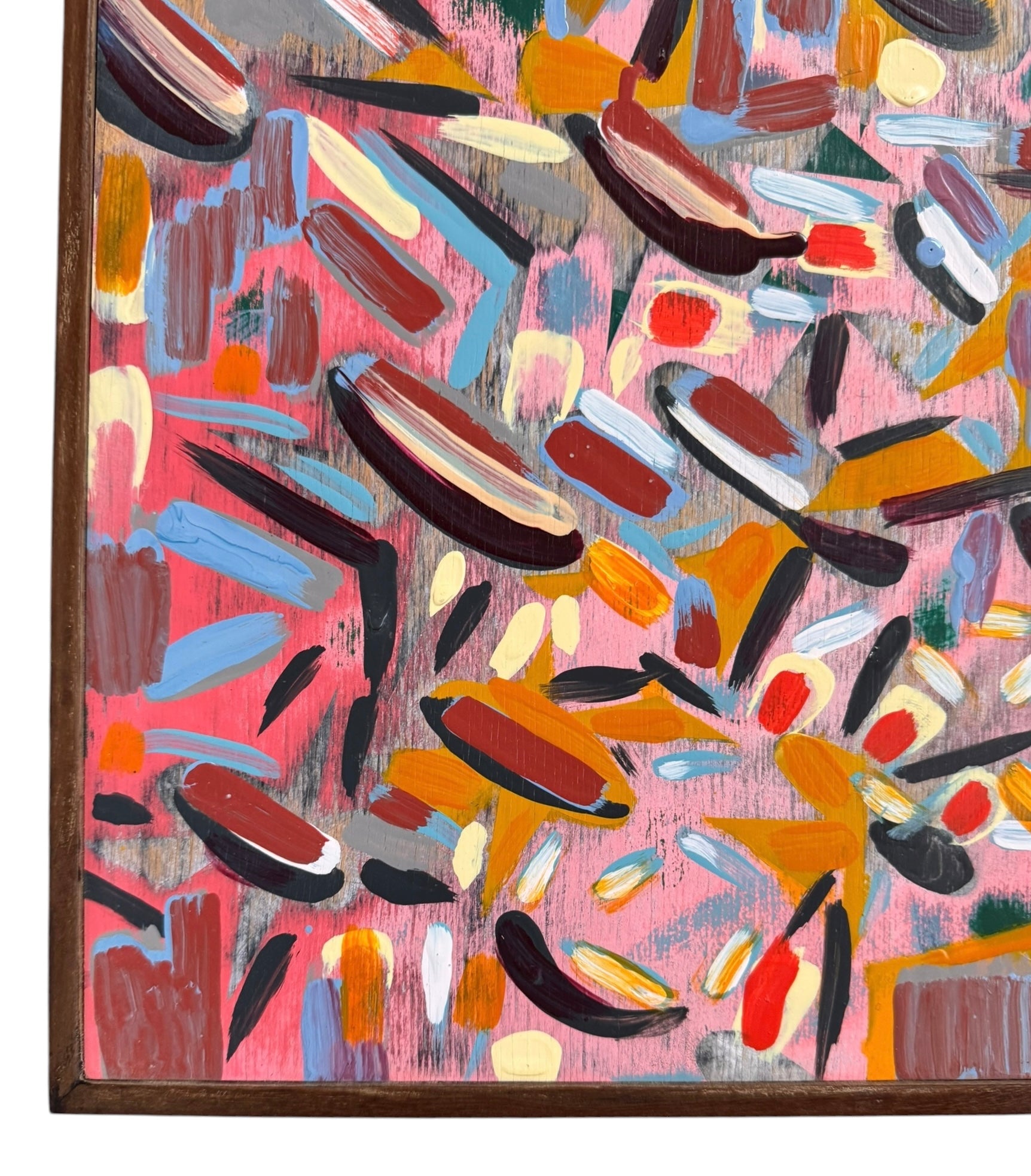 An abstract painting titled 'Cascade of Gold and Pink' by Robert Wymer, framed in dark wood. The artwork features a vibrant pink background densely covered with a dynamic arrangement of multi-directional, oblong, and dash-like brushstrokes in gold, red, blue, gray, white, and black.