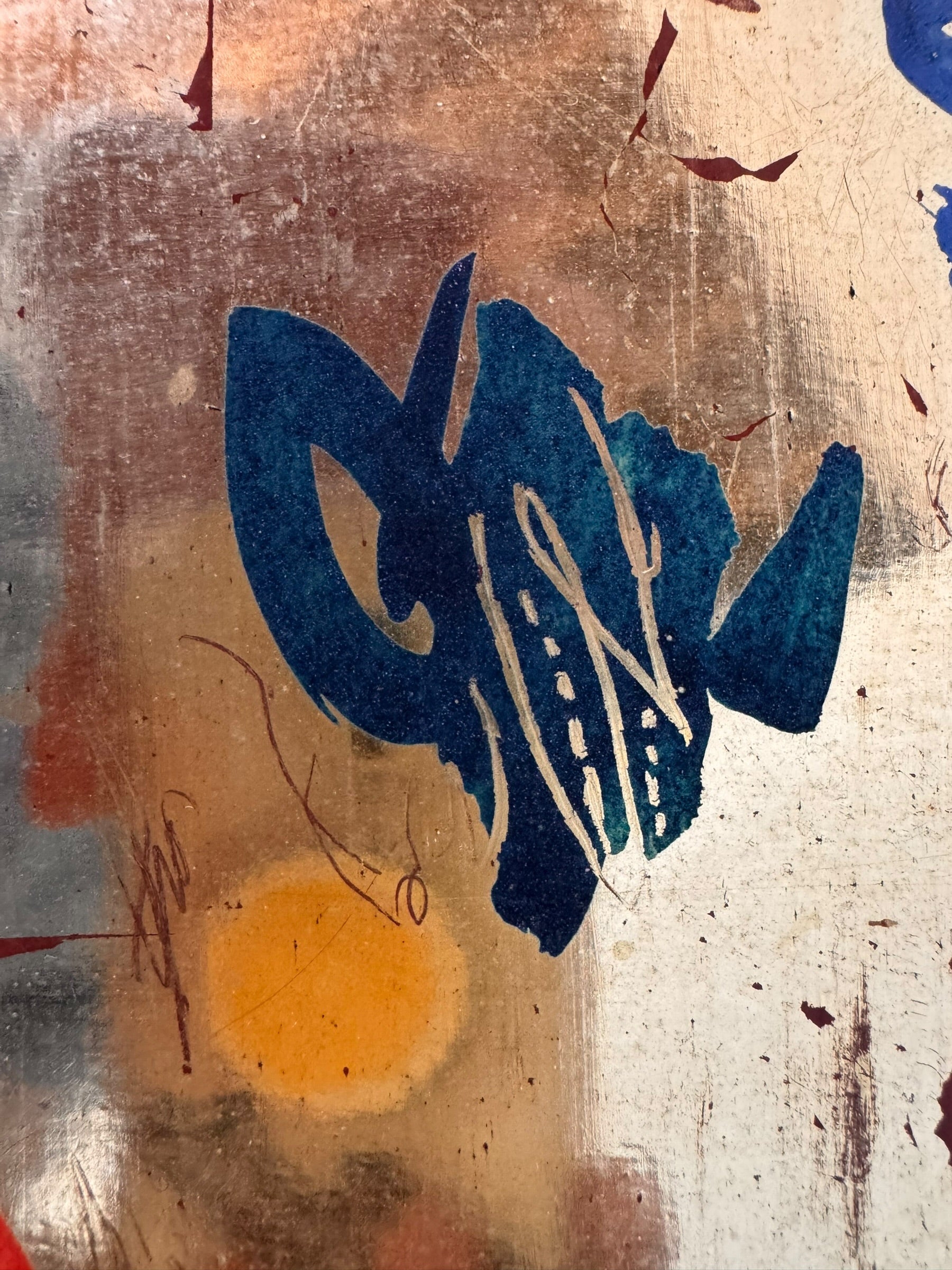 A vertical composition on a bright, reflective metallic background (likely silver or light gold leaf). The piece is defined by sparse, high-energy gestures: a sweeping arc of orange and red at the top, a central cluster of textured red paint, and a scattering of teal-blue "C" shapes and hooks. The metallic surface is highly visible, giving the piece a luminous, modern feel.