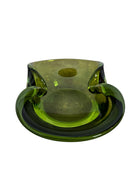 A vintage, Mid-Century Modern, peridot green art glass ashtray or catchall bowl with a curved, free-form design.