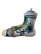 Close-up of Domenico Pinto's 'Mare Dentro' ceramic sculpture: foot, ship with gold sail, Apulian style