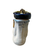 Ceramic foot sculpture by Domenico Pinto featuring hand-painted details, gold accents, a sacred heart, and an angel figure with a blindfold