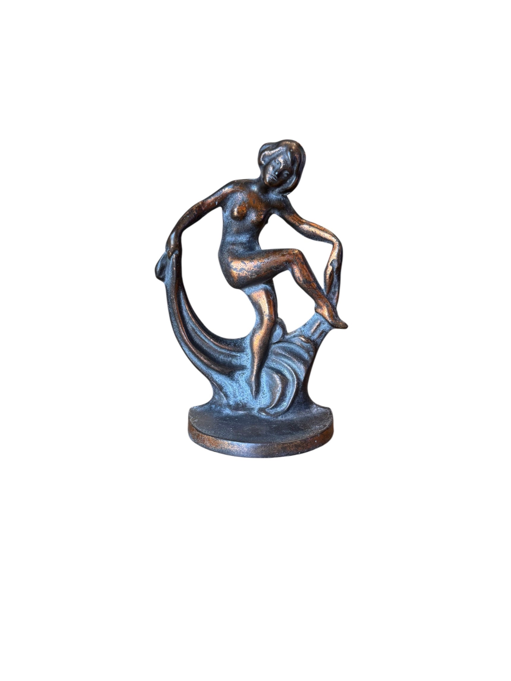 Two cast iron bookends in the Art Deco style. Each features a nude female figure leaning gracefully with one leg extended, posed atop a stylized wave or drape. The bookends have a bronze-colored finish and a vintage appearance.
