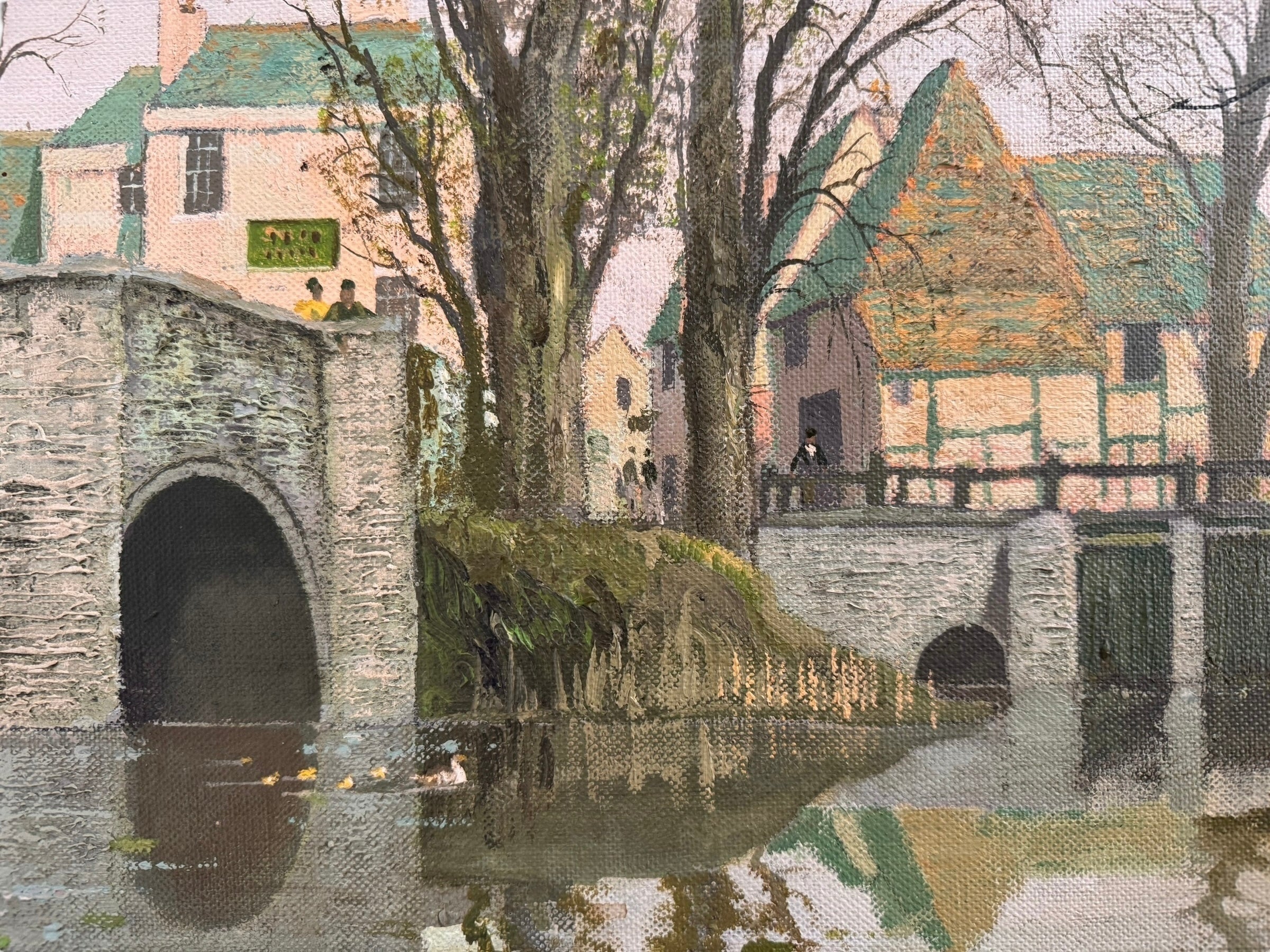 A naturalistic landscape oil painting by Michael Reilly titled "Mill Pond with Bridge" depicts a small town scene with a stone bridge over a mill pond, several buildings, and numerous bare trees under a grey sky
